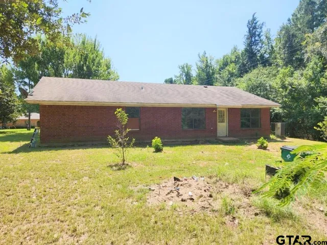 a house with swimming pool in front of it