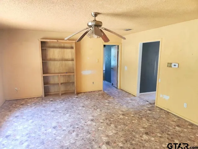 an empty room with closet and wooden floor
