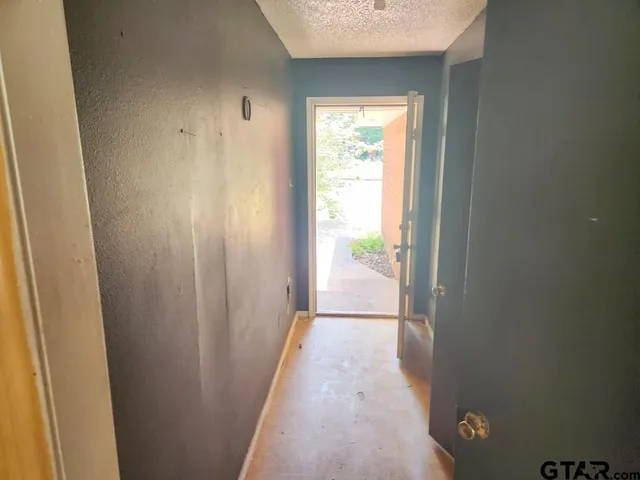 a view of hallway with closet