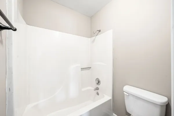 a bathroom with a toilet and a bathtub
