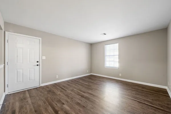 a view of room with window and wooden floor