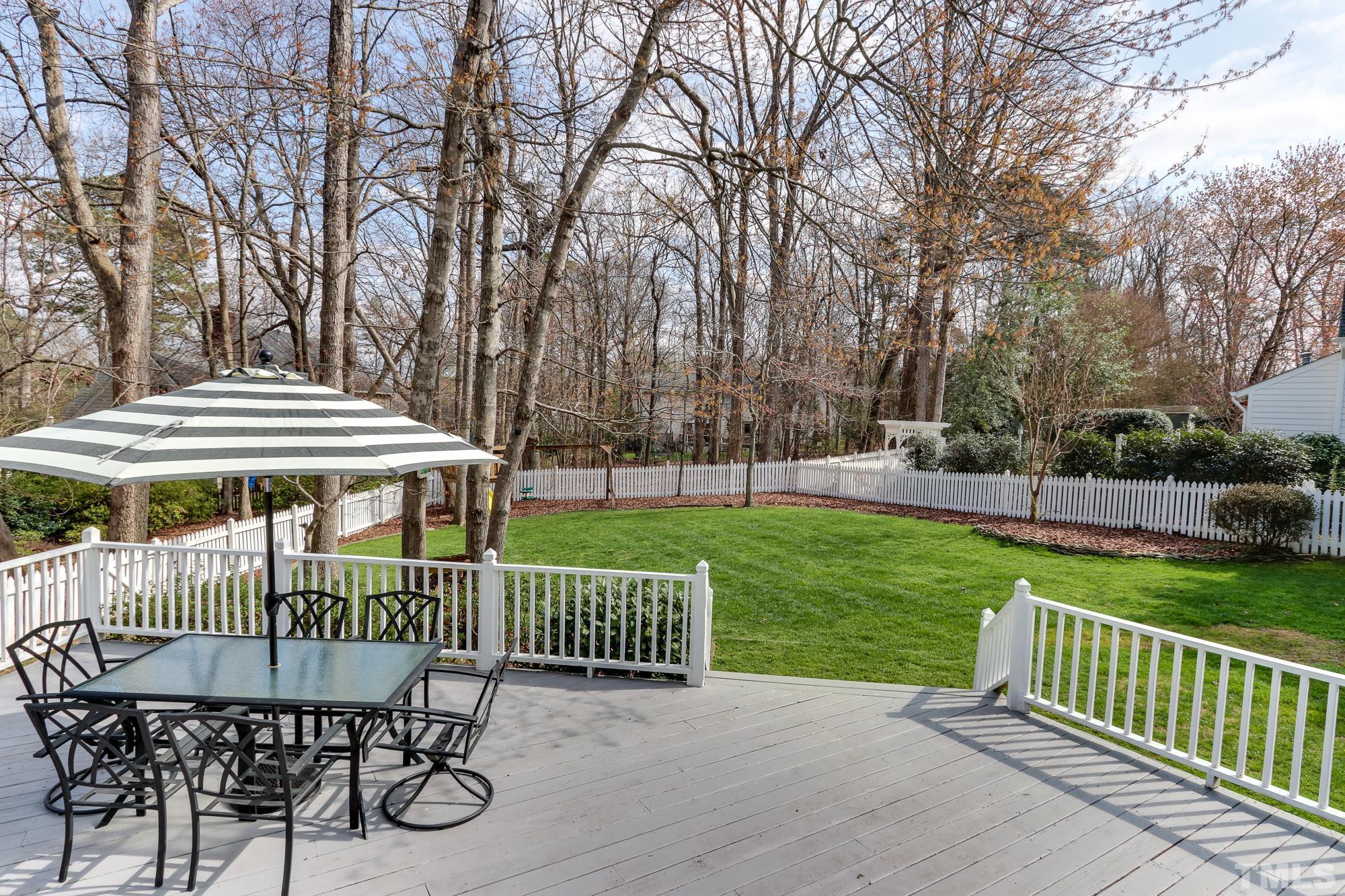 8920 Lindenshire Road Raleigh, NC 27615 - Photo 24 of 26 a view of a chair and table on the deck