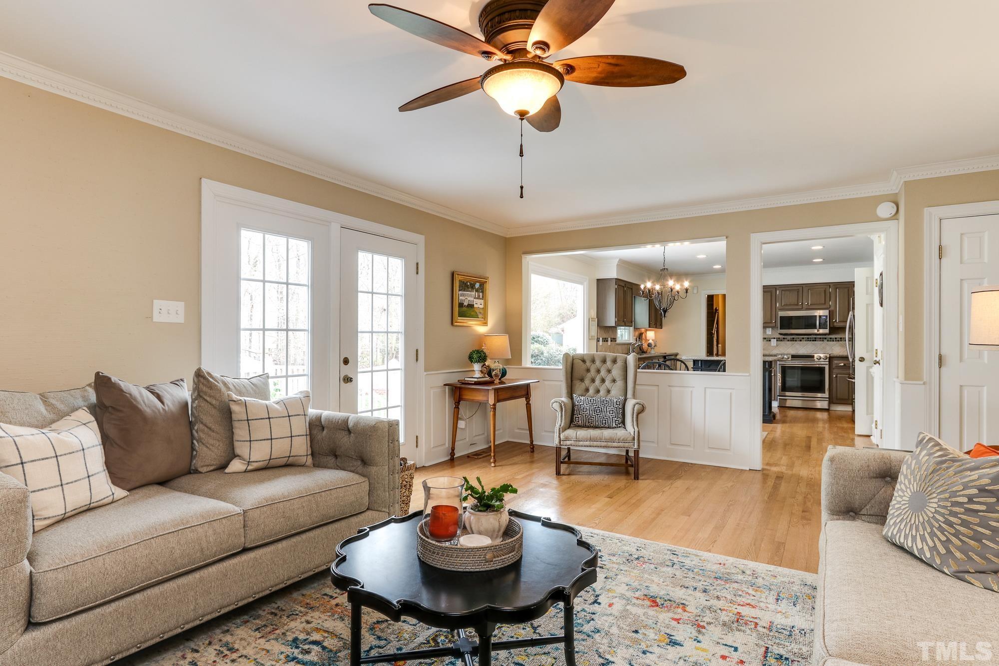 8920 Lindenshire Road Raleigh, NC 27615 - Photo 8 of 26 a living room with furniture and a wooden floor