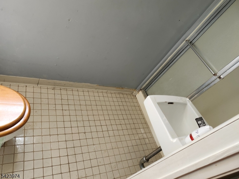 5 Locust Street Wanaque, NJ 07420 - Photo 22 of 23 a bathroom with a sink and a mirror