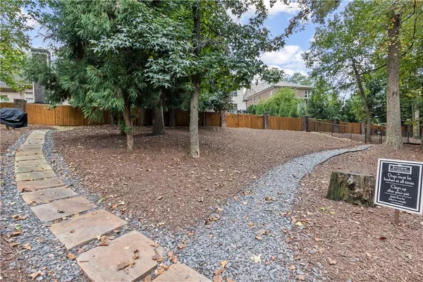 a backyard of a house with trees and entertaining space