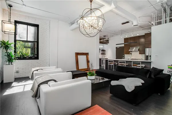a living room with furniture chandelier and a window
