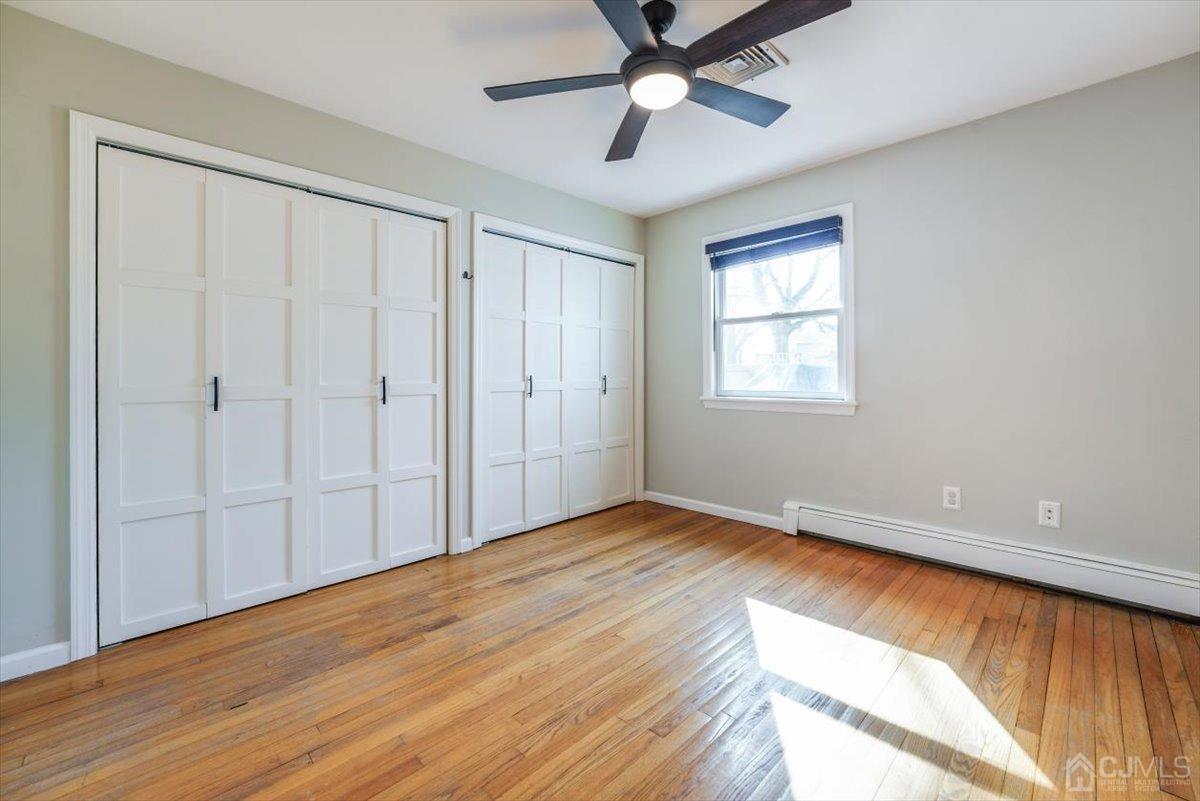 364 New Market Road Dunellen, NJ 08812 - Photo 13 of 36 a view of an empty room with wooden floor and a window