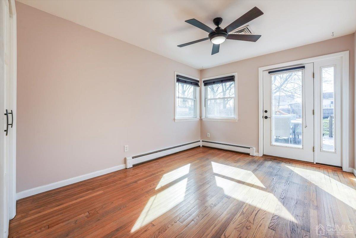 364 New Market Road Dunellen, NJ 08812 - Photo 16 of 36 an empty room with wooden floor and windows