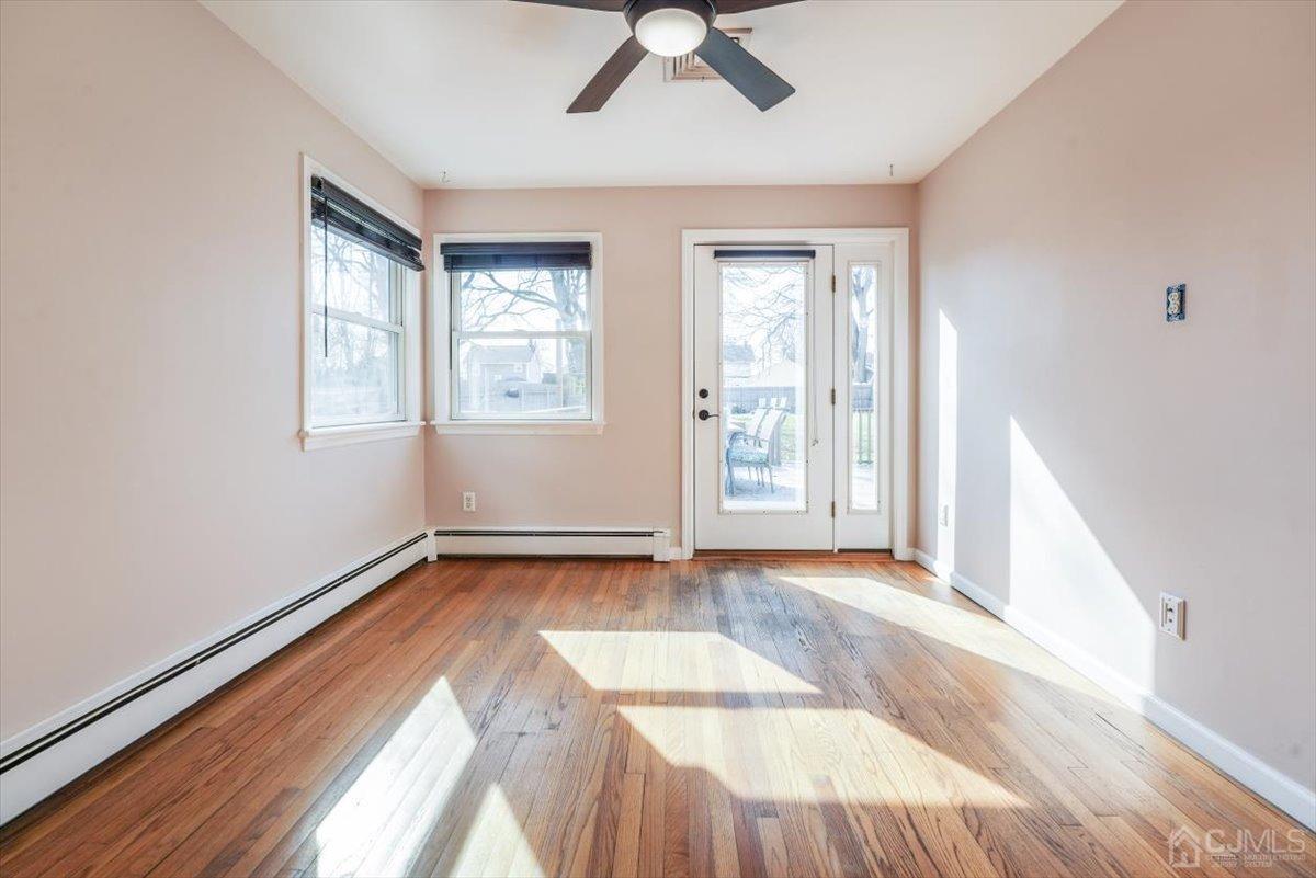 364 New Market Road Dunellen, NJ 08812 - Photo 17 of 36 an empty room with wooden floor and windows