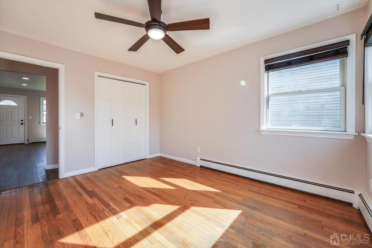364 New Market Road Dunellen, NJ 08812 - Photo 18 of 36 a view of empty room with wooden floor and fan