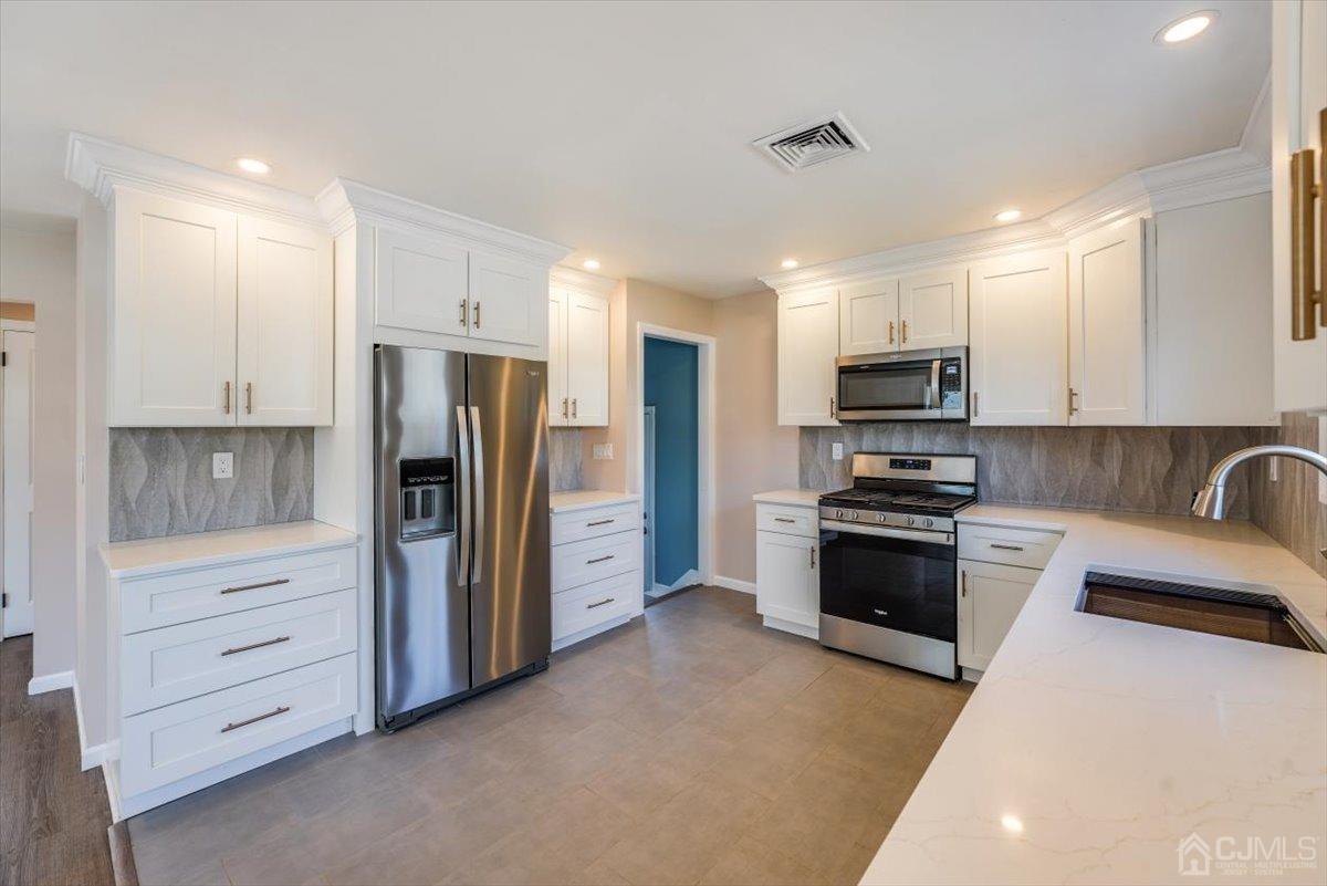 364 New Market Road Dunellen, NJ 08812 - Photo 22 of 36 a kitchen with stainless steel appliances a refrigerator stove and sink