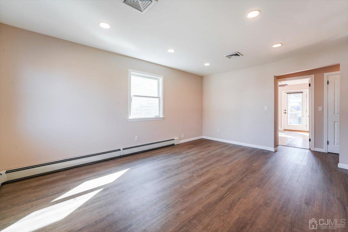 364 New Market Road Dunellen, NJ 08812 - Photo 23 of 36 an empty room with wooden floor and windows