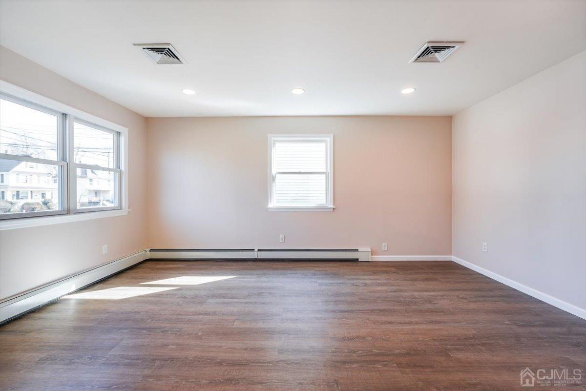 364 New Market Road Dunellen, NJ 08812 - Photo 24 of 36 an empty room with wooden floor and windows