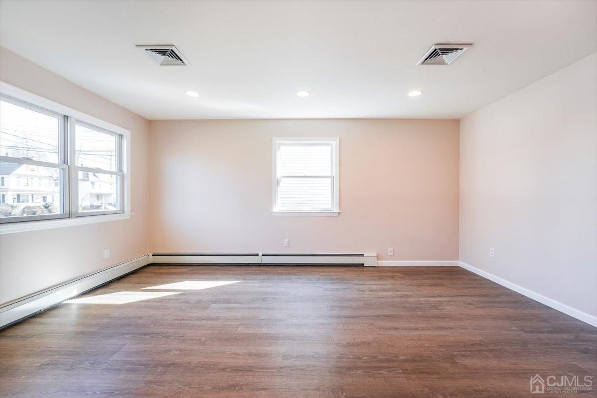 364 New Market Road Dunellen, NJ 08812 - Photo 25 of 36 an empty room with wooden floor and windows