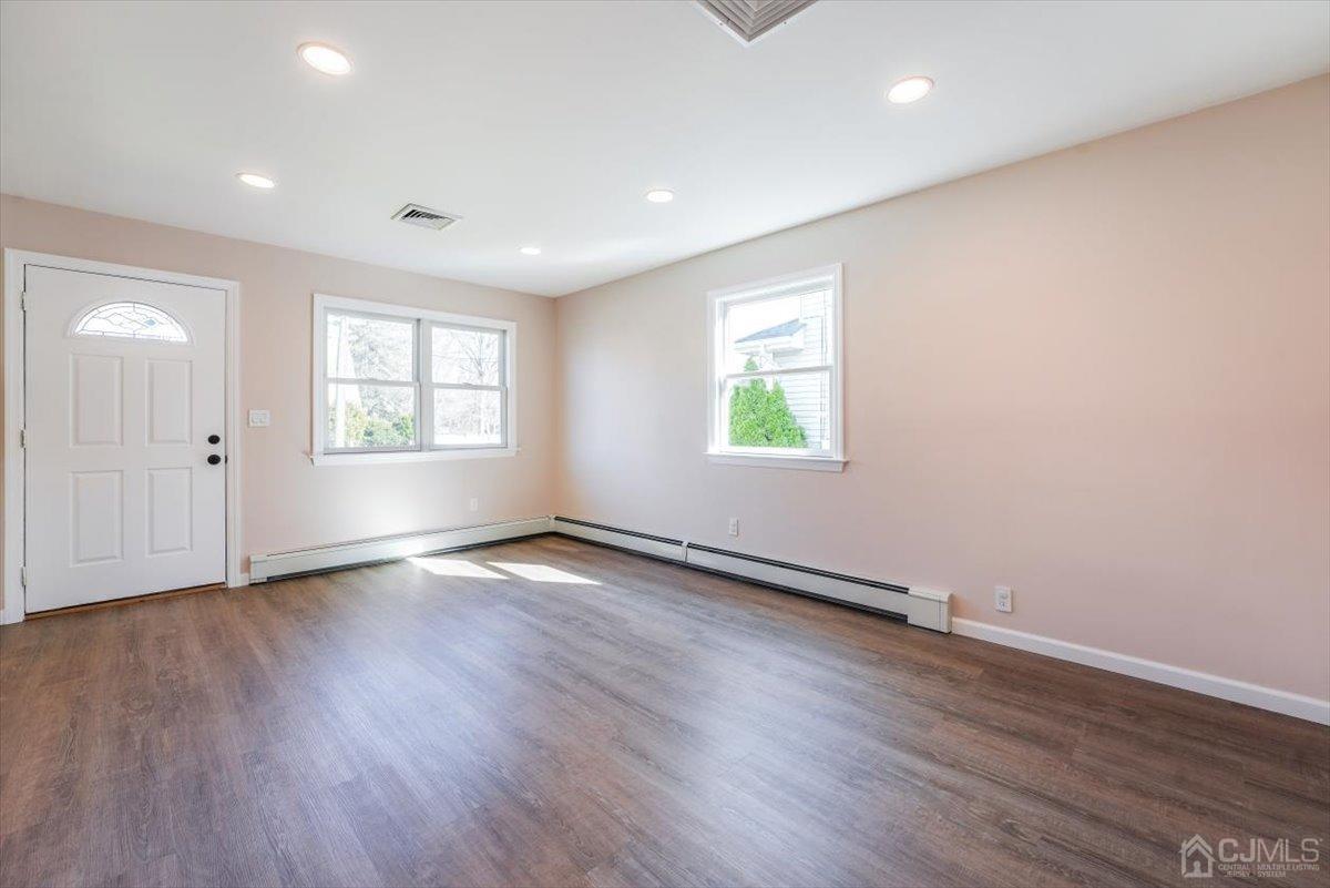 364 New Market Road Dunellen, NJ 08812 - Photo 26 of 36 an empty room with wooden floor and windows