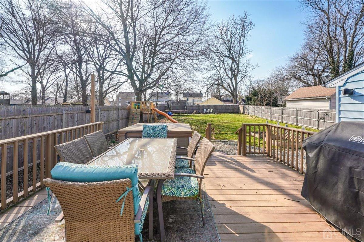 364 New Market Road Dunellen, NJ 08812 - Photo 30 of 36 a view of a chairs and table on the deck