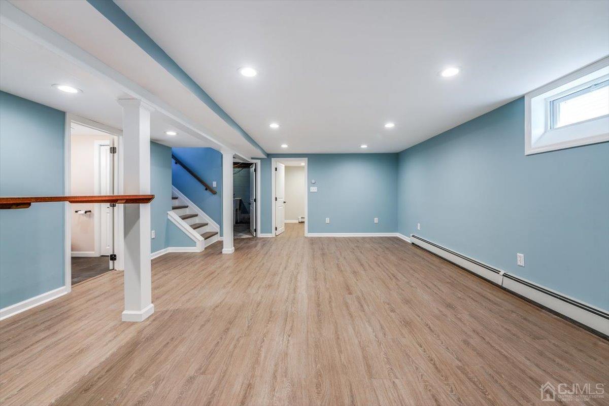 364 New Market Road Dunellen, NJ 08812 - Photo 6 of 36 a view of an empty room with wooden floor