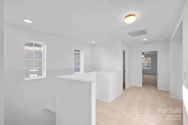 a view of an empty room with a kitchen