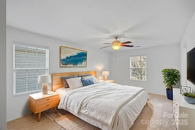 a bedroom with a bed and a chandelier