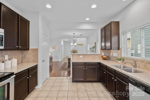 a kitchen with a sink stove top oven and cabinets
