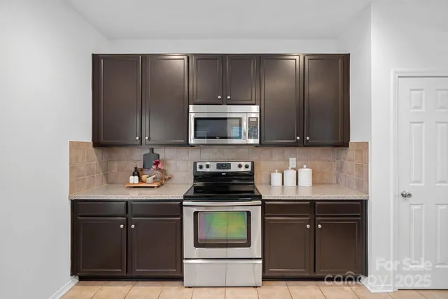 a kitchen with a sink stove and microwave
