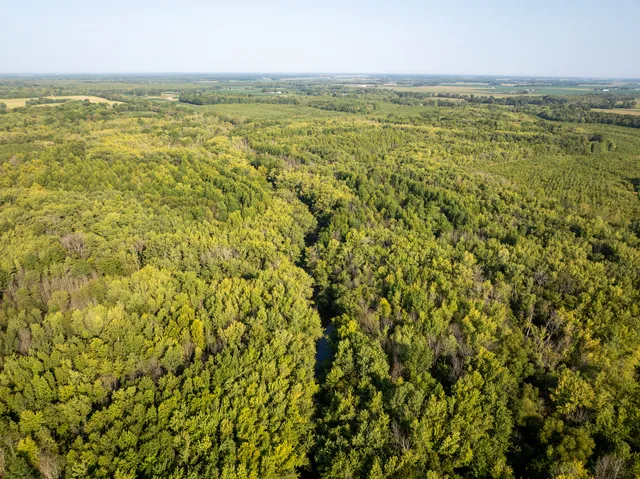 an aerial view of house with yard and mountain view