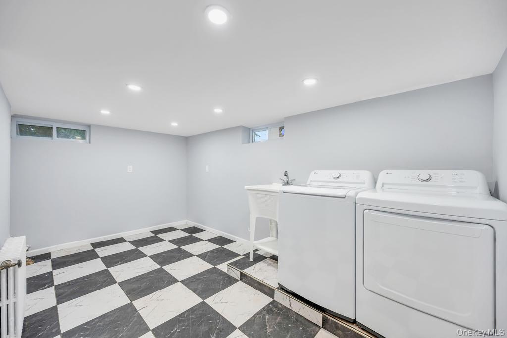 15 Superior Road Bellerose Village, NY 11001 - Photo 18 of 29 Laundry room with recessed lighting, washer and clothes dryer, radiator heating unit, and light floors