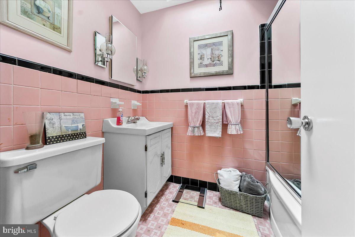 8309 Lynnewood Road Philadelphia, PA 19150 - Photo 20 of 28 a bathroom with a sink mirror vanity and toilet