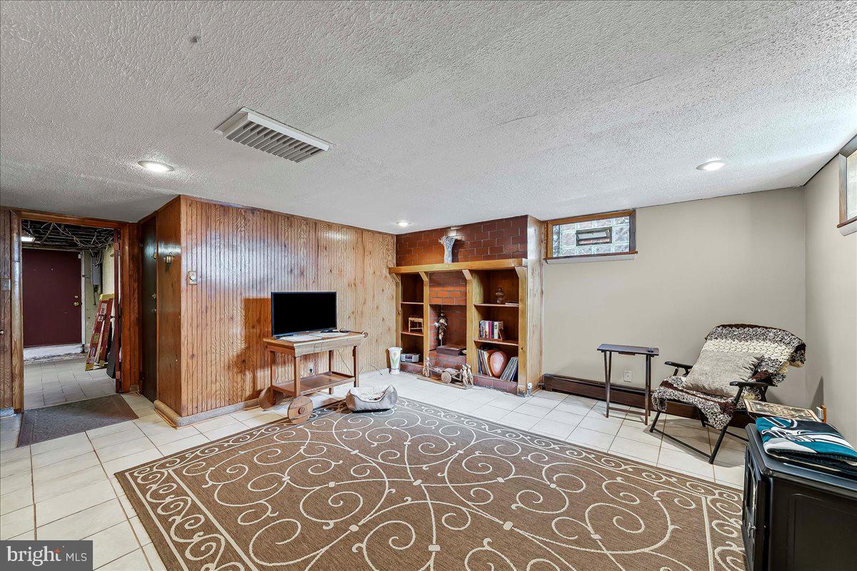 8309 Lynnewood Road Philadelphia, PA 19150 - Photo 21 of 28 a living room with furniture and a flat screen tv