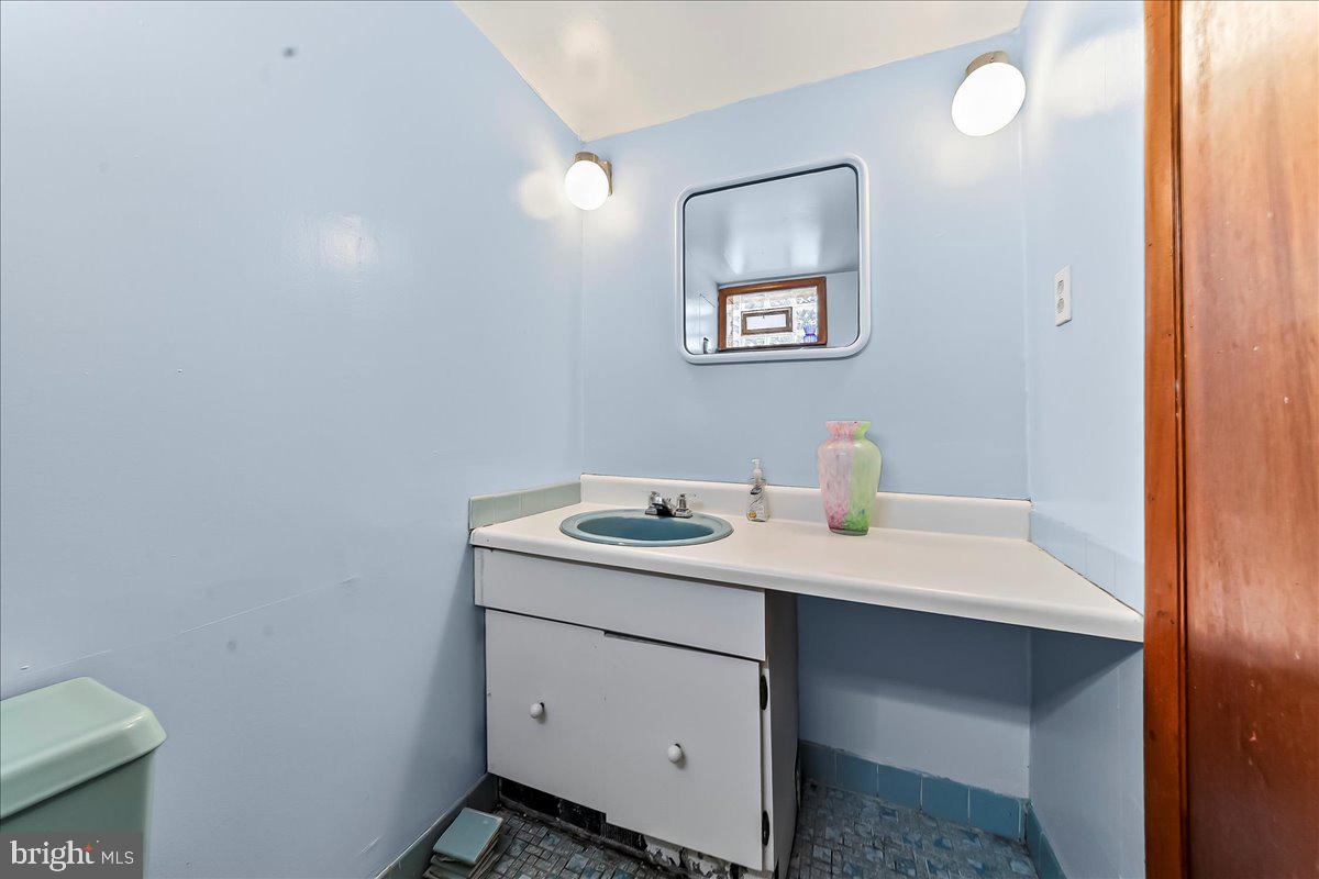 8309 Lynnewood Road Philadelphia, PA 19150 - Photo 24 of 28 a bathroom with a sink toilet and mirror