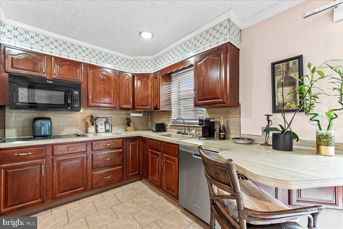 8309 Lynnewood Road Philadelphia, PA 19150 - Photo 7 of 28 a kitchen with a sink stove and microwave