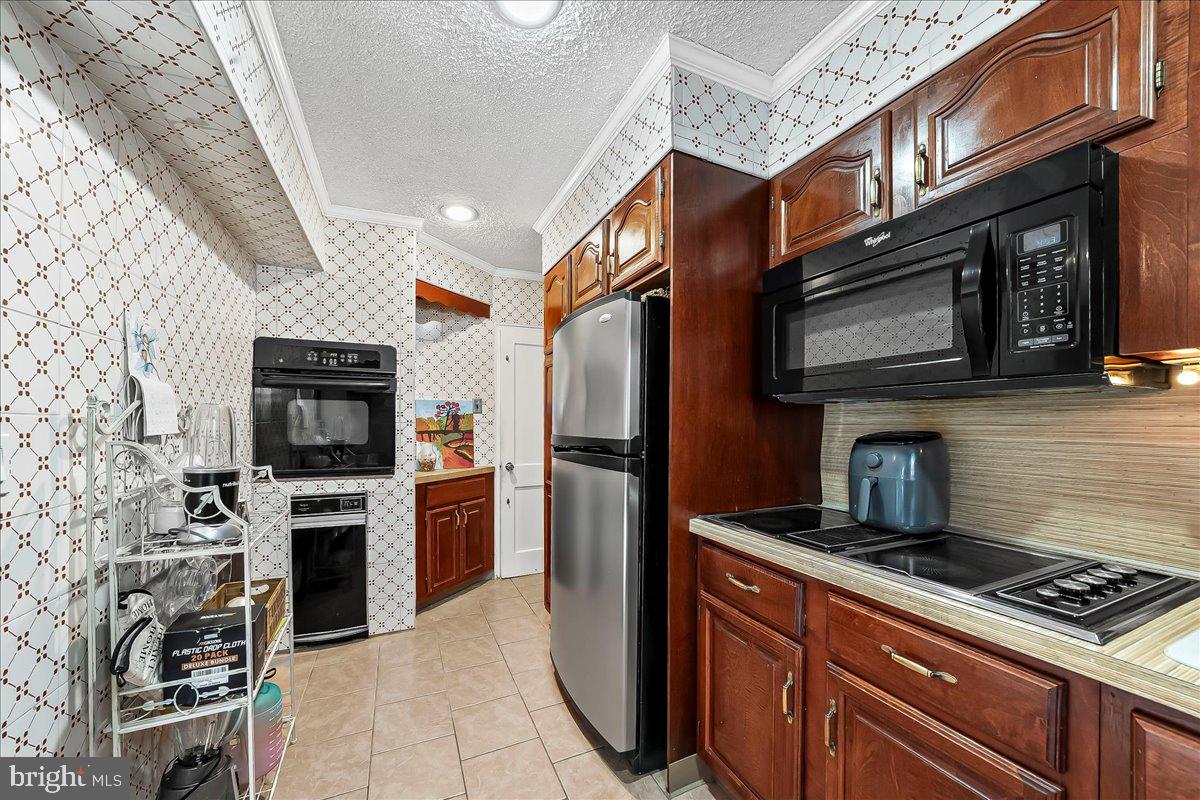 8309 Lynnewood Road Philadelphia, PA 19150 - Photo 8 of 28 a kitchen with stainless steel appliances granite countertop a stove microwave and refrigerator