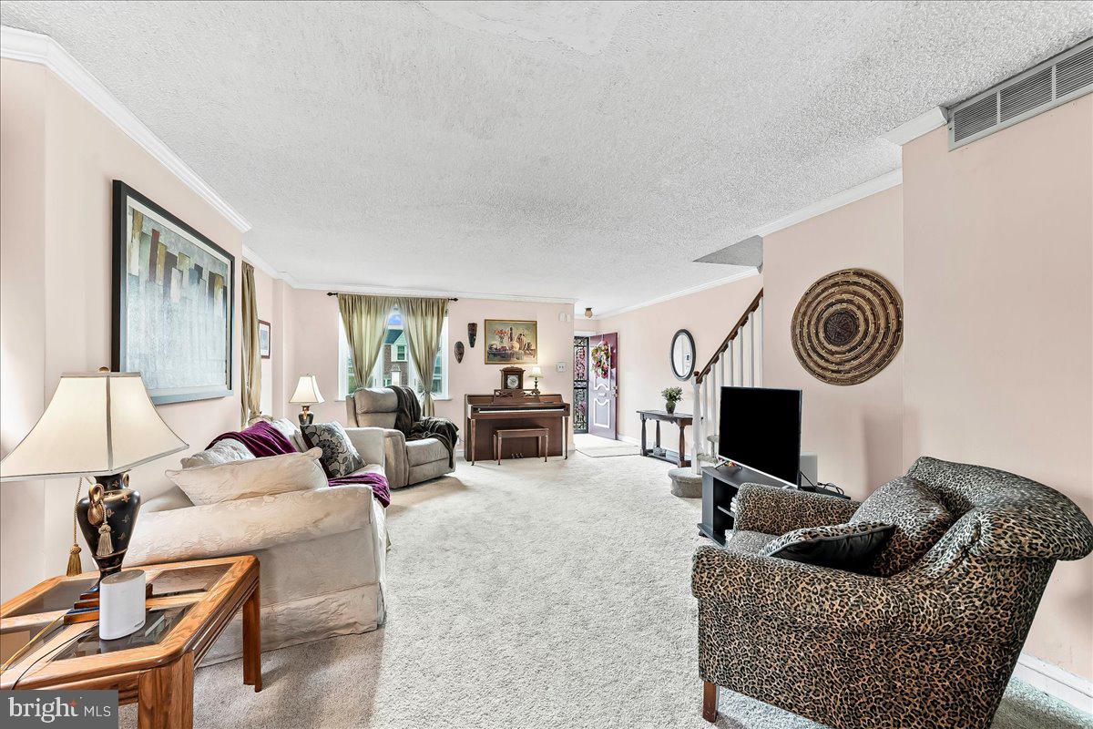 8309 Lynnewood Road Philadelphia, PA 19150 - Photo 10 of 28 a living room with furniture and a fireplace