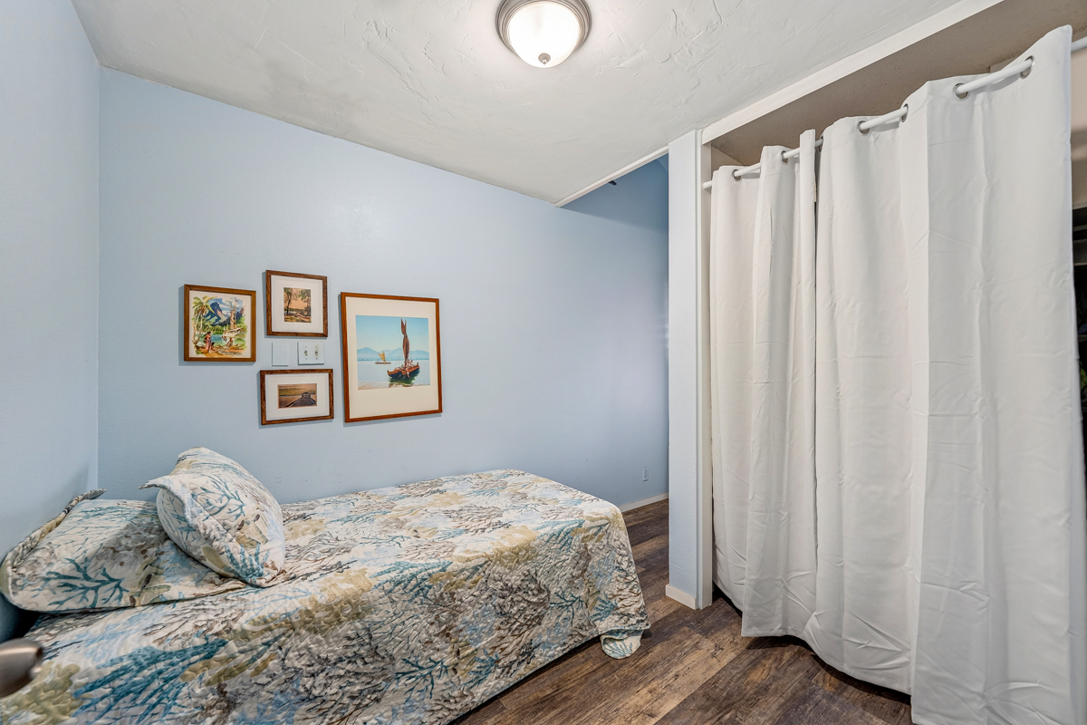 3411 Wilcox Road, Unit BV25 Lihue, HI 96766 - Photo 14 of 21 a bedroom with a bed and a curtain