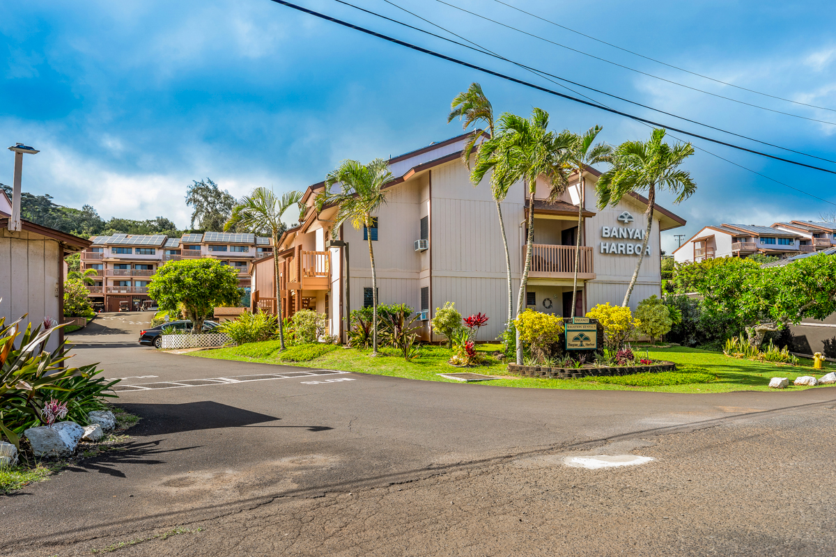 3411 Wilcox Road, Unit BV25 Lihue, HI 96766 - Photo 15 of 21 a front view of a house with a yard and potted plants