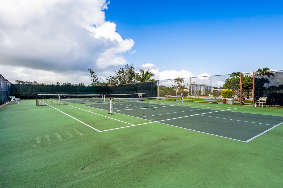 3411 Wilcox Road, Unit BV25 Lihue, HI 96766 - Photo 18 of 21 a view of a tennis ground with large trees