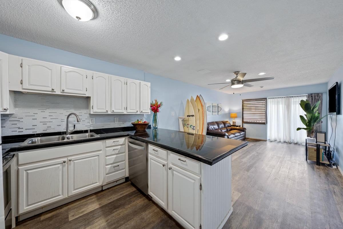 3411 Wilcox Road, Unit BV25 Lihue, HI 96766 - Photo 2 of 21 a kitchen with granite countertop a sink cabinets and wooden floor