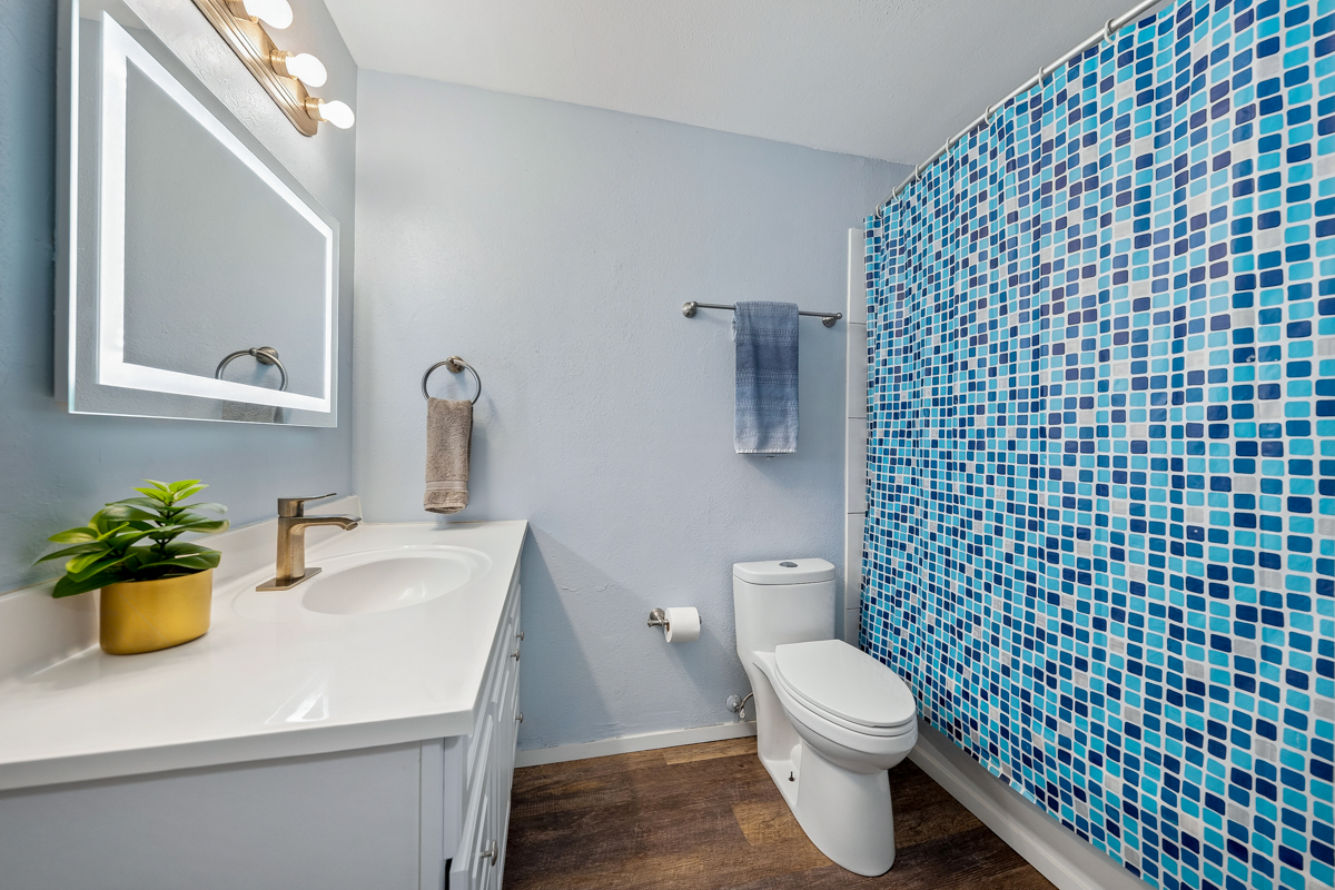 3411 Wilcox Road, Unit BV25 Lihue, HI 96766 - Photo 10 of 21 a bathroom with a sink a toilet and a mirror
