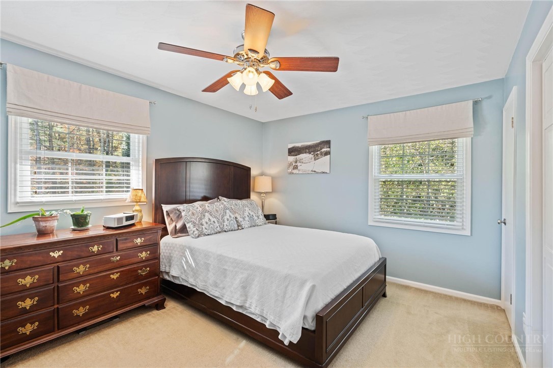 112 Chandy Street Boone, NC 28607 - Photo 18 of 50 a bedroom with a bed and a chandelier