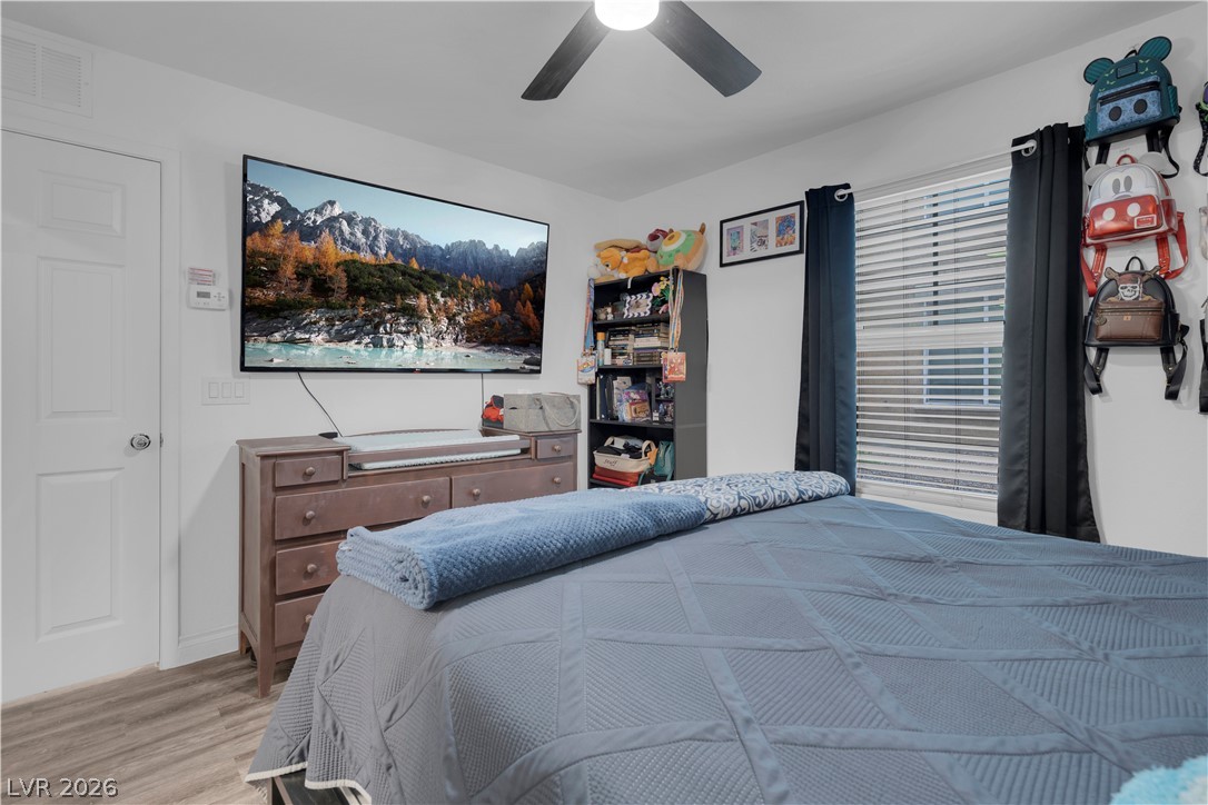 4536 Woolcomber Street Las Vegas, NV 89115 - Photo 11 of 34 Bedroom featuring ceiling fan and wood finished floors