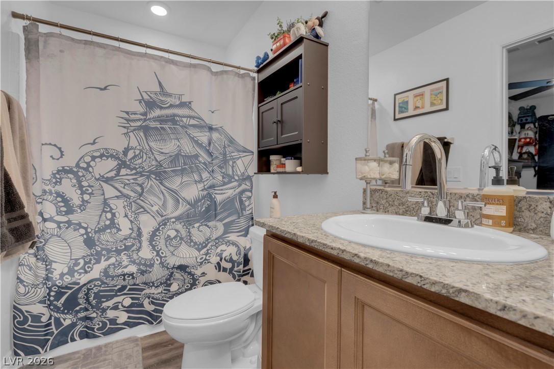 4536 Woolcomber Street Las Vegas, NV 89115 - Photo 13 of 34 Bathroom with vanity, a shower with curtain, and light wood-style floors
