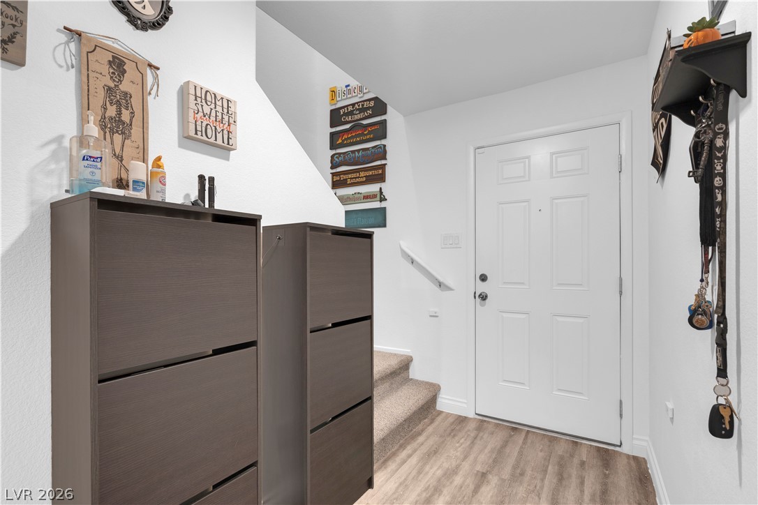 4536 Woolcomber Street Las Vegas, NV 89115 - Photo 15 of 34 Foyer with light wood-type flooring and stairs