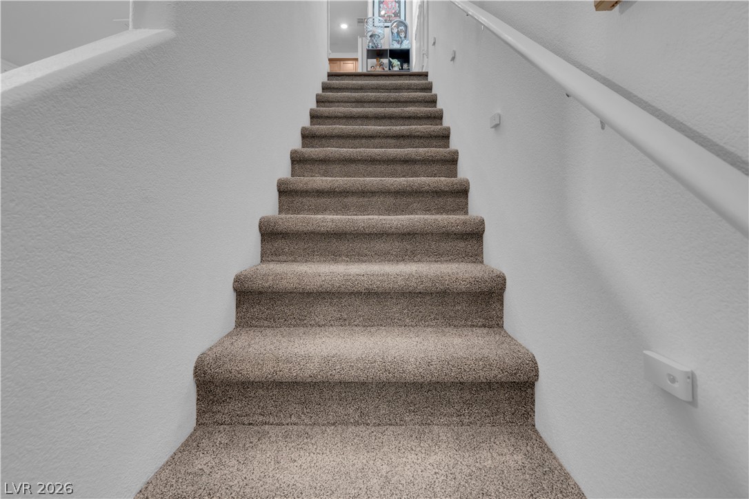 4536 Woolcomber Street Las Vegas, NV 89115 - Photo 16 of 34 Staircase with a textured wall