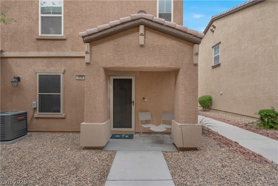 4536 Woolcomber Street Las Vegas, NV 89115 - Photo 2 of 34 Property entrance with stucco siding and a tiled roof
