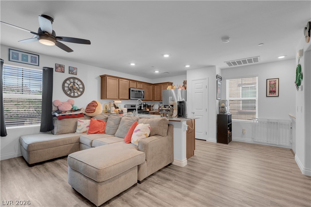 4536 Woolcomber Street Las Vegas, NV 89115 - Photo 21 of 34 Living room featuring light wood finished floors, recessed lighting, and a ceiling fan