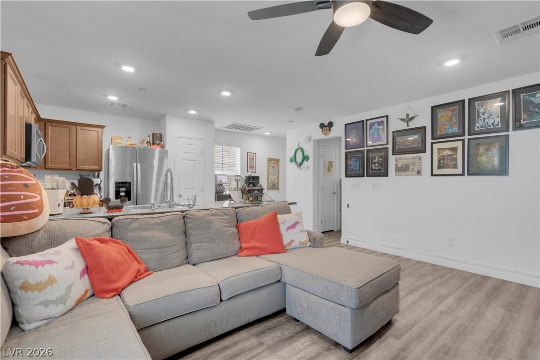 4536 Woolcomber Street Las Vegas, NV 89115 - Photo 22 of 34 Living room with a ceiling fan, recessed lighting, and light wood finished floors