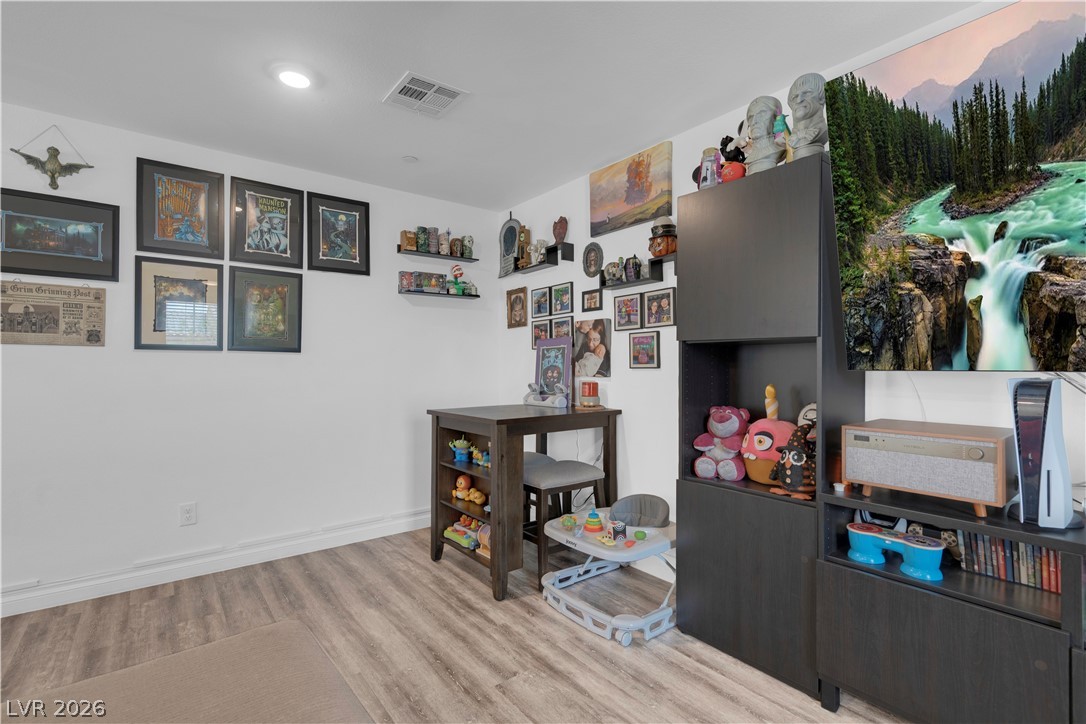 4536 Woolcomber Street Las Vegas, NV 89115 - Photo 23 of 34 Rec room featuring light wood finished floors and baseboards