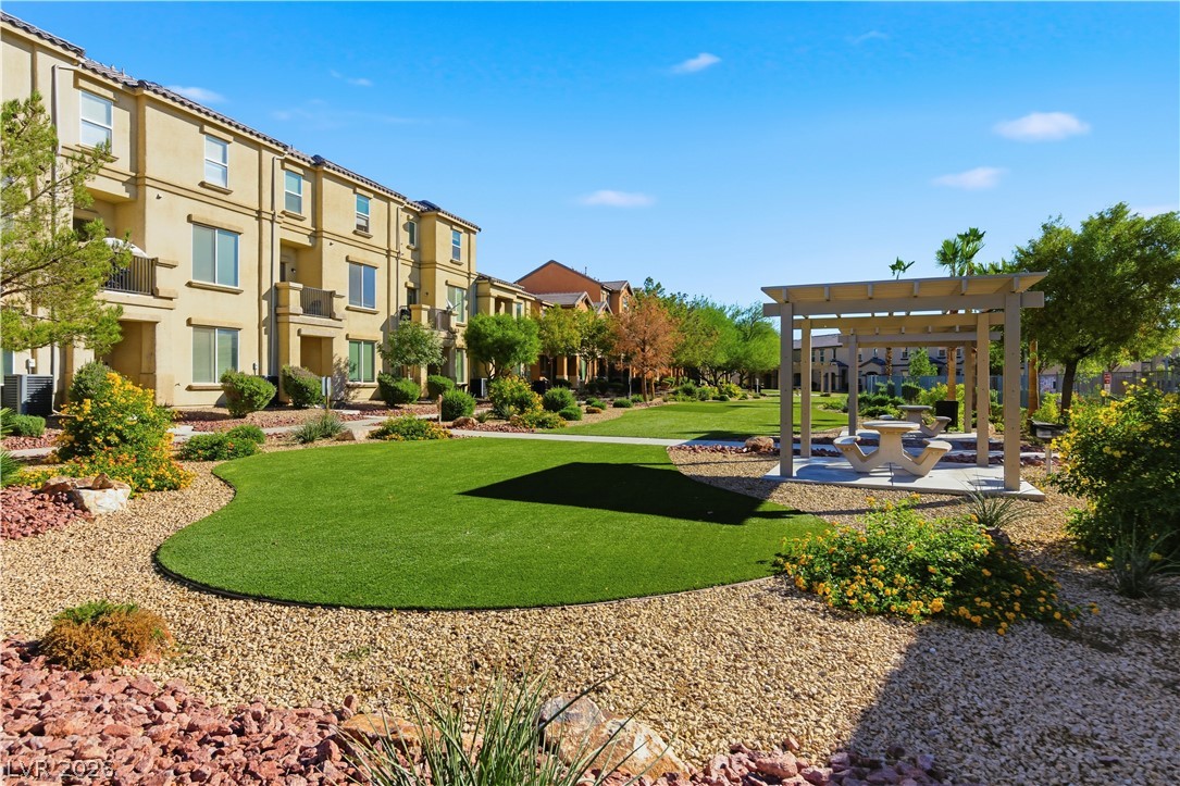 4536 Woolcomber Street Las Vegas, NV 89115 - Photo 28 of 34 View of community with a patio area and a pergola