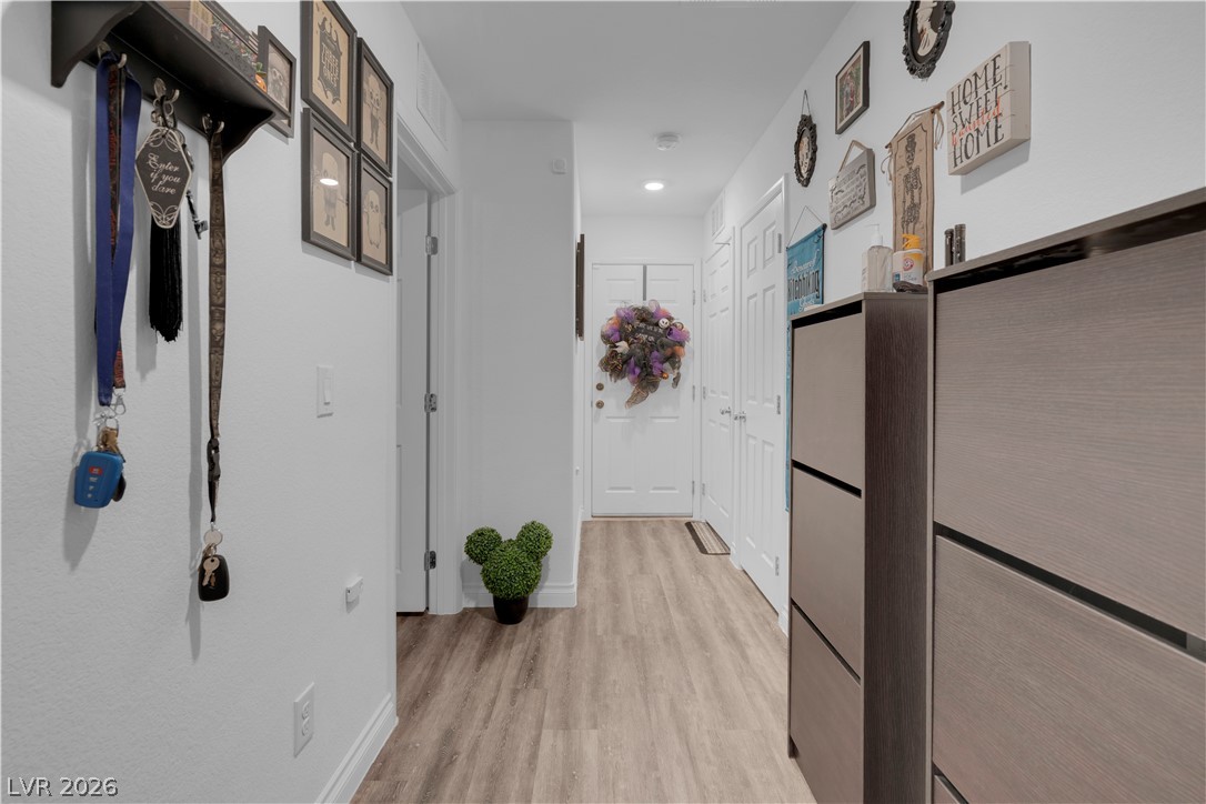 4536 Woolcomber Street Las Vegas, NV 89115 - Photo 7 of 34 Hallway with light wood-type flooring and recessed lighting
