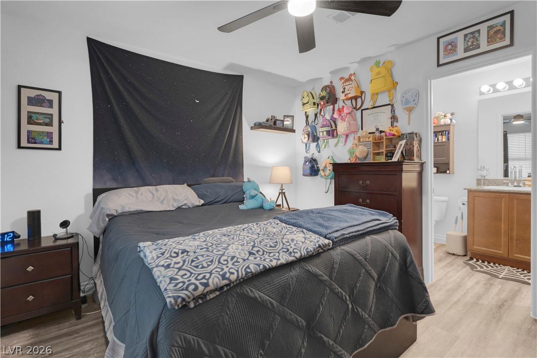 4536 Woolcomber Street Las Vegas, NV 89115 - Photo 9 of 34 Bedroom featuring light wood finished floors and a ceiling fan